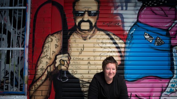 Graffiti artist Kaff-eine with her portrait of Mark "Chopper" Reid.