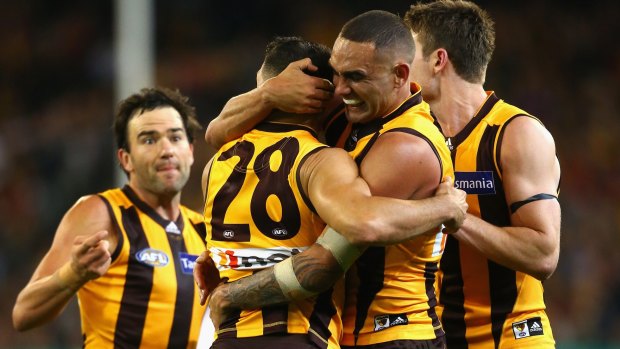 Hawks on high: Shaun Burgoyne embraces Paul Puopolo after the siren in the win against Adelaide.