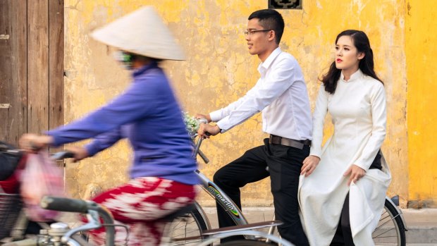 Locals on bicycles in the historic centre of Hoi An, Vietnam.