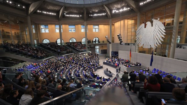 Politicians sit during a session inside the lower-house of the German Parliament in Berlin on Tuesday.