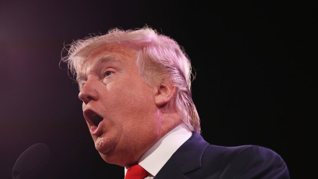 Donald Trump's attacks on potential candidates Mitt Romney and Jeb Bush won applause.