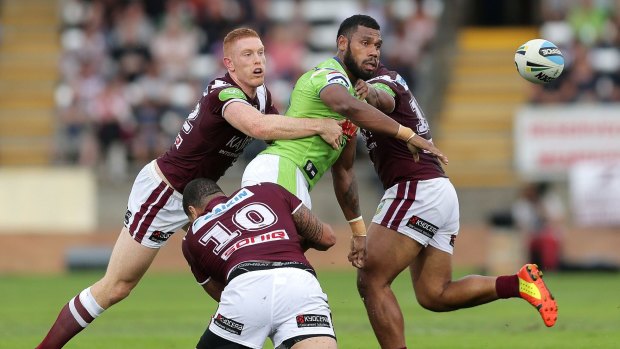 The Raiders' Sisa Waqa offloads during the round five NRL match against the Manly Sea Eagles in Albury.