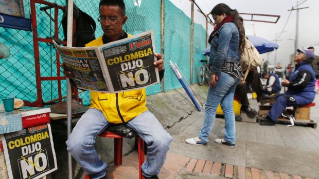 A man reads a newspaper with the headline that reads in Spanish: "Colombia said No" in Bogota on Monday.