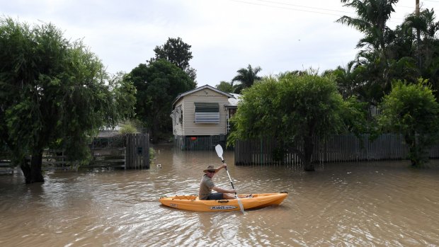 A resident in the flooded streets of Rockhampton during the aftermath of Cyclone Debbie in April 2017.