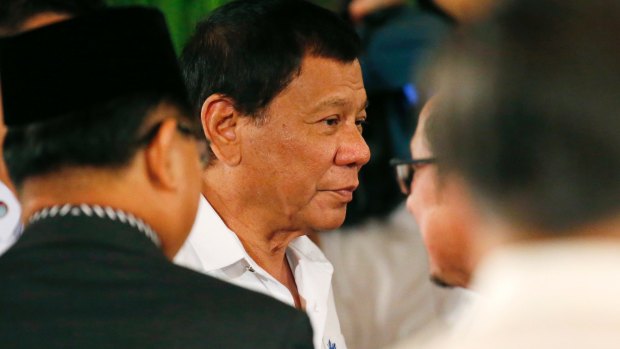 Philippine President Rodrigo Duterte addresses Filipino Muslim leaders last week, promising to rebuild Marawi.