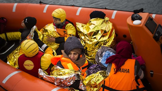 Refugees and migrants onboard a dinghy arrive at the Greek island of Lesbos, after crossing the Aegean sea from Turkey on January 2.