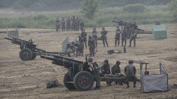 A tense place: South Korean army soldiers prepare to fire howitzers during an exercise in Paju, South Korea, near the border with North Korea on Wednesday.