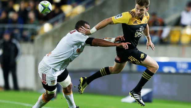 Beauden Barrett of the Hurricanes keeps the ball in play.