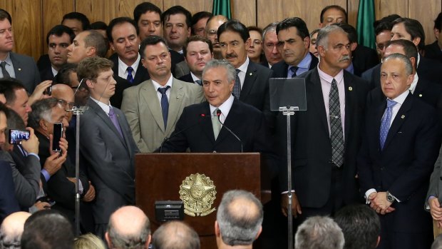 Michel Temer, Brazil's acting president, centre, delivers his first speech in Brasilia last week.