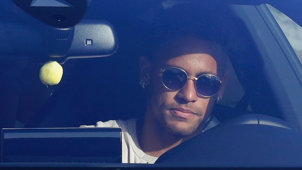 Sad goodbye: Neymar in his car outside Barcelona's training grounds on Wednesday.