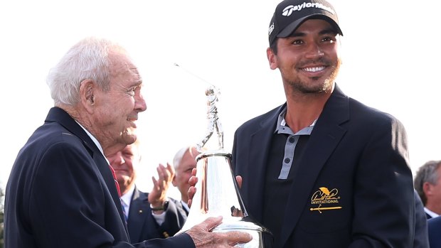 Silver service: Arnold Palmer presents the championship trophy to Jason Day.
