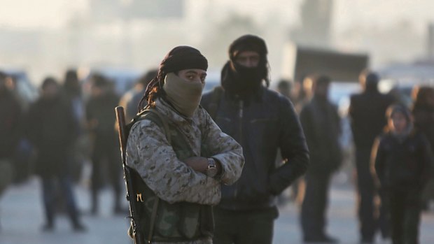 Armed Syrian fighters evacuated from Aleppo during the ceasefire arrive at a refugee camp in Rashidin, near Idlib, on December 20.