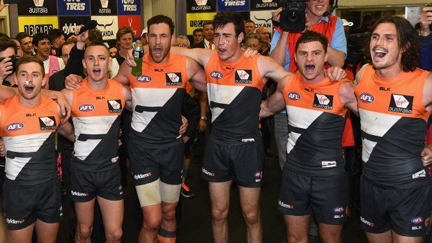 In full voice: Devon Smith, Tom Scully, Shane Mumford, Jeremy Cameron, Heath Shaw and Phil Davis sing the GWS team song in the rooms.