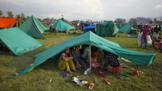 Locals take shelter in makeshift tents after Saturday's deadly quake in Nepal.