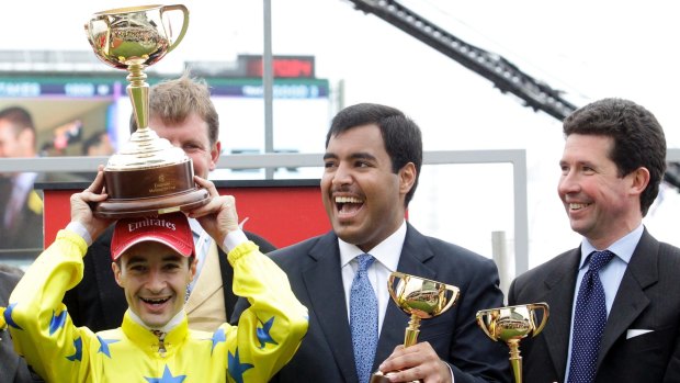 Sheikh Fahad Al Thani (centre) with French jockey Christophe Lemaire and trainer Mikel Delzangles after Dunaden won the 2011 Melbourne Cup. 