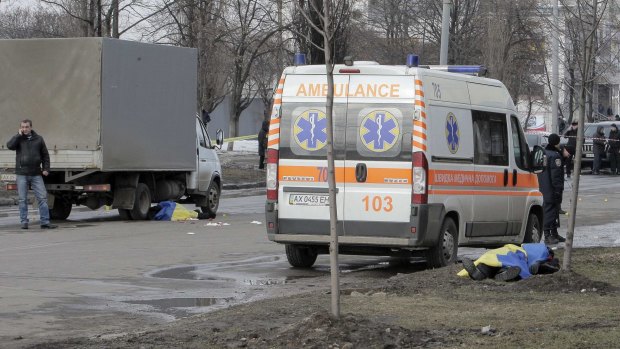 Ukrainian national flags cover the bodies of the victims of Sunday's bomb attacks in Kharkiv.  