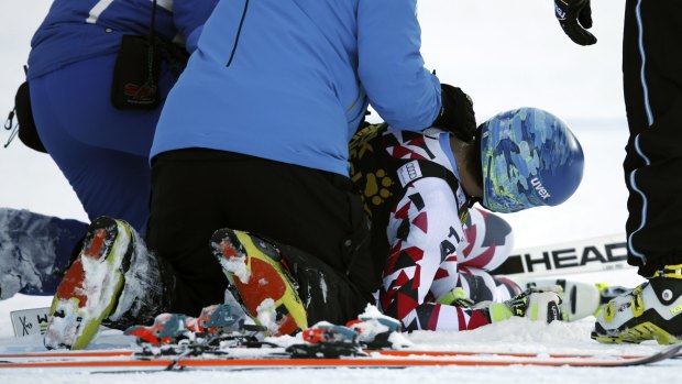 Austria's Matthias Mayer lies on the snow after crashing on Saturday.
