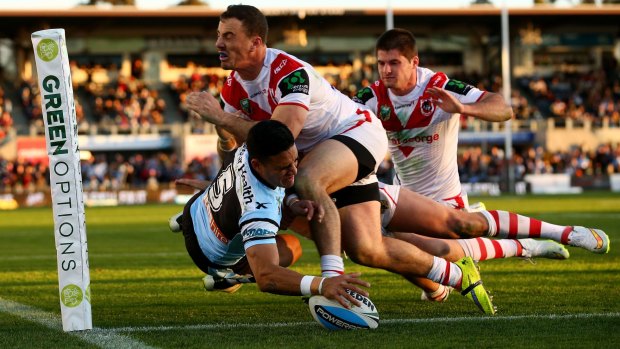 Full stretch: Valentine Holmes touches down for the Sharks.