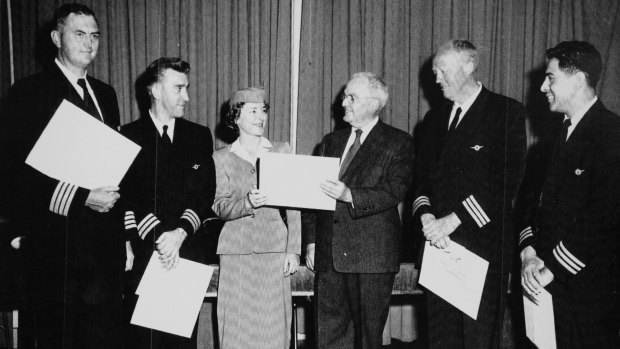 Crew members received an award for their work aboard Pan Am Flight 6. From left, Capt. Richard Ogg, Richard Brown, the navigator; Pat Reynolds, the purser; unidentified man giving award, first officer George L. Haaker, and Frank Garcia, the flight engineer. 