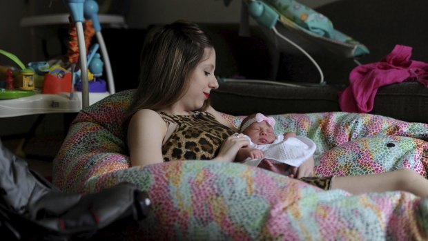 Taylor, 16, with her 13-day-old daughter, Aaliyah, at Erin House, one of two homes in north Canberra run by Karinya House for vulnerable pregnant women and new mothers.