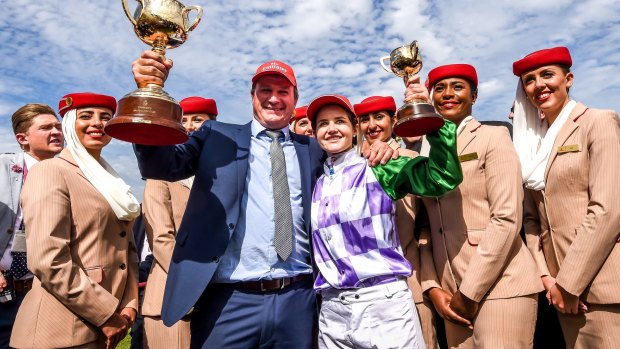 Winners are grinners: Darren Weir and Michelle Payne celebrate their Melbourne Cup win in 2015. 