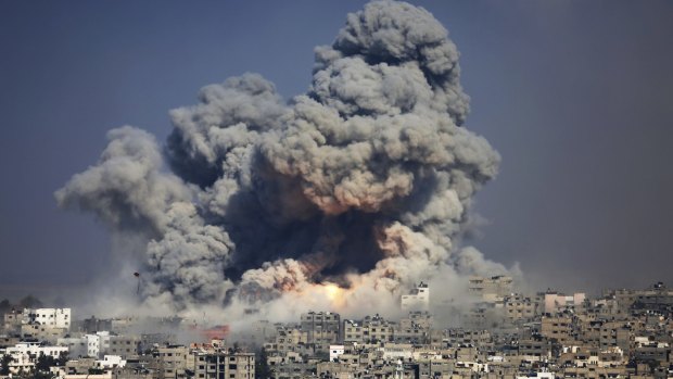 Smoke and fire from the explosion of an Israeli strike rise over Gaza City on July 29, 2014.
