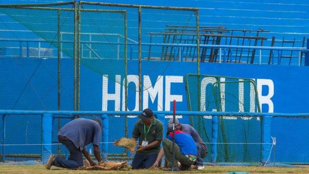 Workers replace the grass at the Latinoamericano Stadium baseball arena in Havana. Barack Obama plans to attend the Tampa Bay Rays' exhibition game at the arena on March 22.