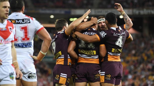 Job done: Brisbane players celebrate after scoring a try.