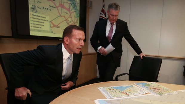 Then prime minister Tony Abbott is briefed by ASIO director-general Duncan Lewis on Islamic State in June. 