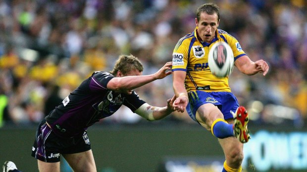 The big dance: Jeff Robson gets a kick away despite the tackle of Brett Finch during the 2009 NRL Grand Final between the Parramatta Eels and the Melbourne Storm at ANZ Stadium.
