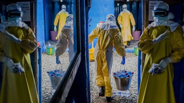 Workers enter the high-risk zone of the Bong County Ebola Treatment Unit in Suakoko, Liberia during the height of the Ebola crisis last year.