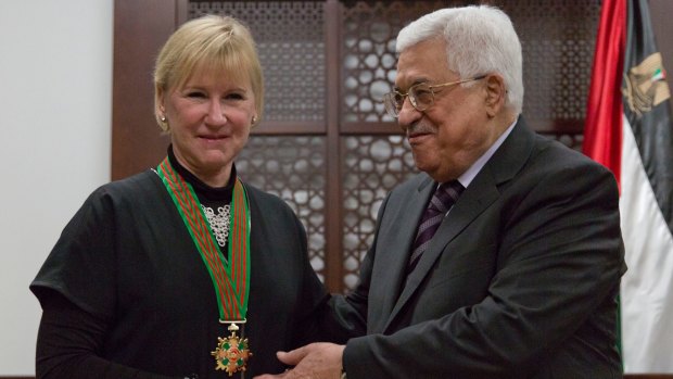 Mahmoud Abbas decorates Swedish Foreign Minister Margot Wallstrom with the "Grand Star of the Order of Jerusalem" at his office in Ramallah on December 15. Israeli officials have boycotted Ms Wallstrom's visit to the region.