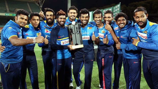 Sri Lankan players celebrate with their trophy after winning the series but losing the match.