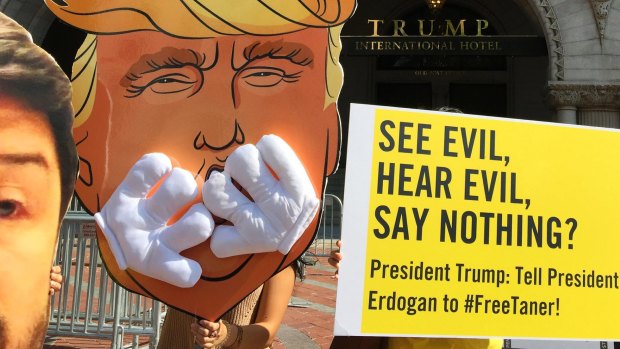 Members of Amnesty International protest outside Trump International Hotel in Washington in  June.