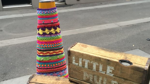 A yarn-bombed bollard outside Little Mule Cafe in Melbourne.