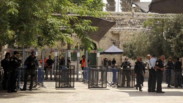 Israeli border police officers stand near security gates at the holy site.