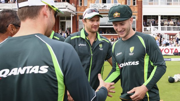 Welcome: Steve Smith and Shane Watson congratulate Peter Nevill after he receives his first baggy green.
