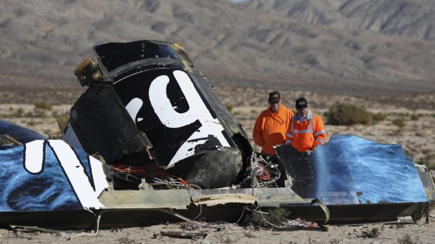 Out of the blue: Police look at wreckage of the Virgin Galactic SpaceShipTwo.