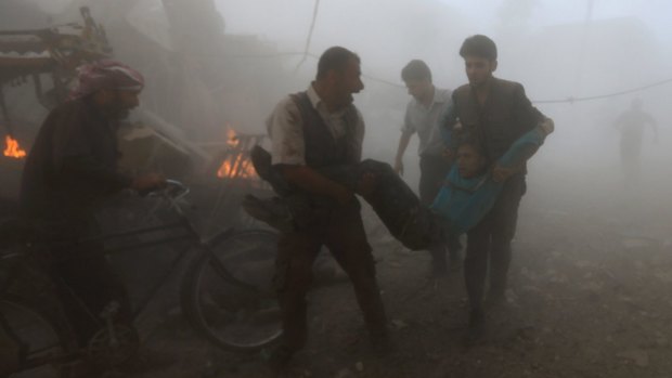 An injured person is moved to safety after what observers say were air strikes by forces loyal to Syria's President Bashar al-Assad near Damascus on Sunday.