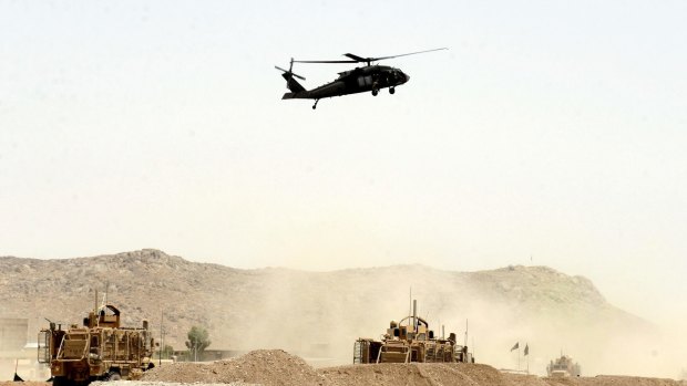 US military helicopter flies over the site of a suicide bomb that struck a NATO convoy in Kandahar south of Kabul.