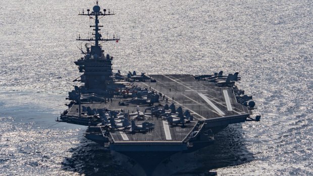 Aircraft carrier USS Harry S Truman navigates the Gulf of Oman on Christmas Day. The US Navy is being asked to tread a fine line in the world's relationship with China. 