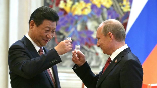 Gan bei, na zdorovie: China's president Xi Jinping  and Russia's president Vladimir Putin raise their glasses after signing joint documents in Shanghai last year. 