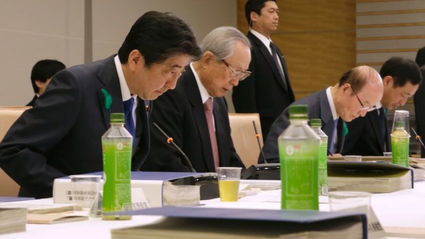 Japanese Prime Minister Shinzo Abe, left, and Takashi Imai, second left, who presented the final report on a special law for Emperor Akihito's abdication process.