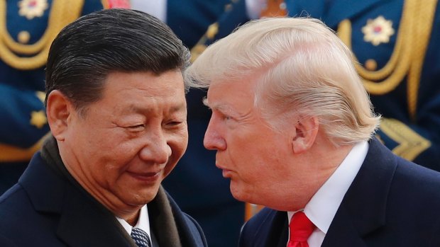 US President Donald Trump, right, chats with Chinese President Xi Jinping during a welcome ceremony at the Great Hall of the People in Beijing earlier this month.