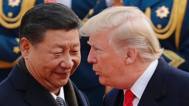US President Donald Trump chats with Chinese President Xi Jinping during a welcome ceremony at the Great Hall of the People in Beijing, 2017.