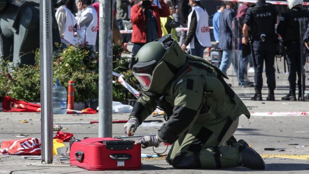 A Turkish bomb disposal expert investigates a suitcase at the scene of a blast during a peace rally in Ankara in October.