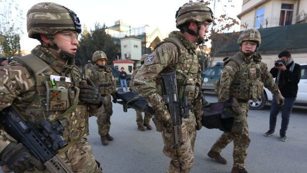 British soldiers carry the body of a victim of an attack  near the Spanish Embassy, in Kabul, last week.