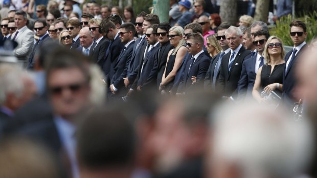Australian cricketers and other mourners line a route for the funeral procession of Australian cricketer Phillip Hughes in his home town of Macksville.