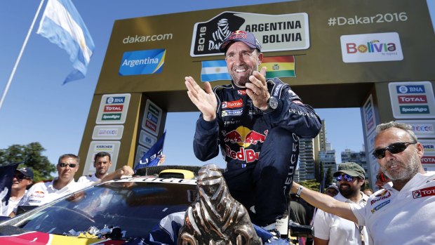 Relief: Peugeot driver Stephane Peterhansel smiles after receiving the 2016 Dakar Rally winner's trophy.