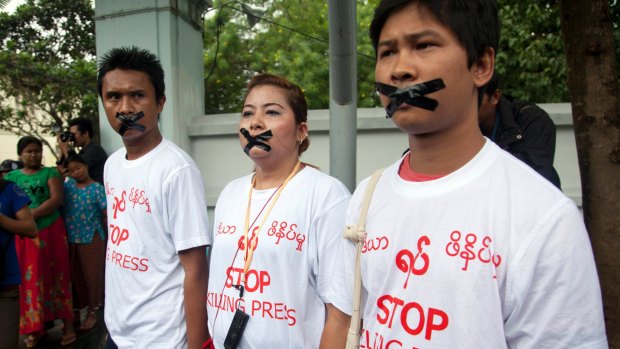 Myanmar journalist Thet Oo Maung, known as Wa Lone, right, stands in 2014 with other journalists with their mouths taped, symbolising the government's crackdown on the media.
